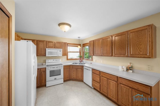 14691 Ramblehurst Dr, Perrysburg, OH 43551 - kitchen featuring white appliances, brown cabinets, light countertops, and hanging light fixtures