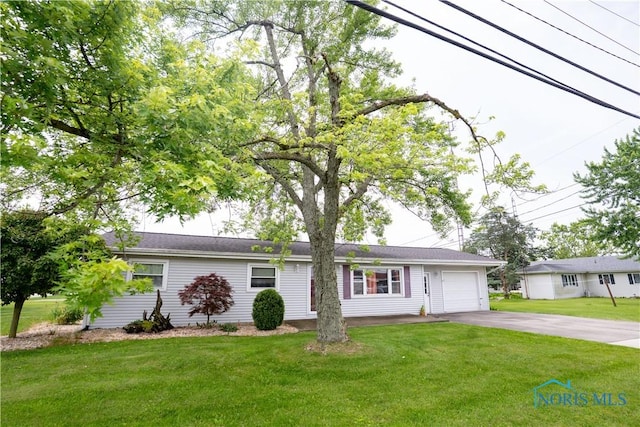 317 E Rosewood Ave, Defiance, OH 43512 - ranch-style house featuring asphalt driveway, a garage, and a front lawn