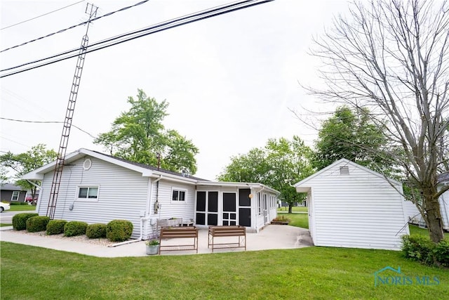317 E Rosewood Ave, Defiance, OH 43512 - rear view of property featuring a sunroom, a patio, and a lawn