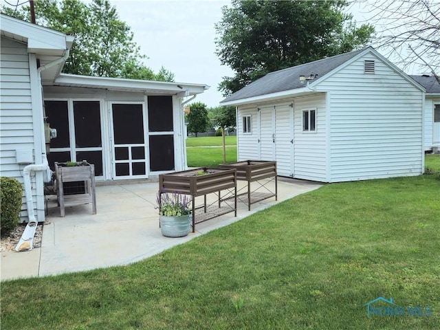 317 E Rosewood Ave, Defiance, OH 43512 - view of patio / terrace with a sunroom and an outbuilding