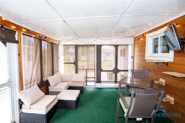 317 E Rosewood Ave, Defiance, OH 43512 - sunroom / solarium featuring carpet floors, wooden walls, and outdoor lounge area