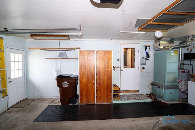 317 E Rosewood Ave, Defiance, OH 43512 - garage with gas water heater, a garage door opener, and heating unit