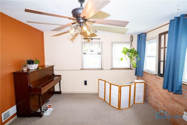 317 E Rosewood Ave, Defiance, OH 43512 - living area with healthy amount of natural light, carpet flooring, a ceiling fan, and wainscoting
