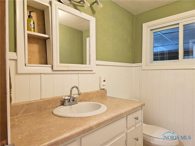 317 E Rosewood Ave, Defiance, OH 43512 - half bath featuring vanity and a wainscoted wall