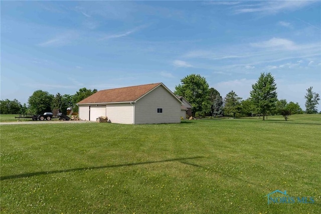 10549 Cygnet Rd, Cygnet, OH 43413 - view of side of property with a detached garage, a lawn, and an outdoor structure