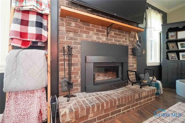 10549 Cygnet Rd, Cygnet, OH 43413 - detailed view of crown molding, a brick fireplace, and wood finished floors