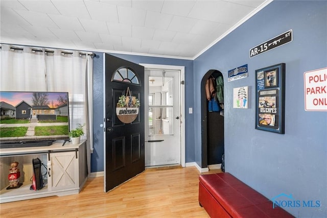 411 Seneca St, Defiance, OH 43512 - entryway with light wood finished floors, arched walkways, and ornamental molding