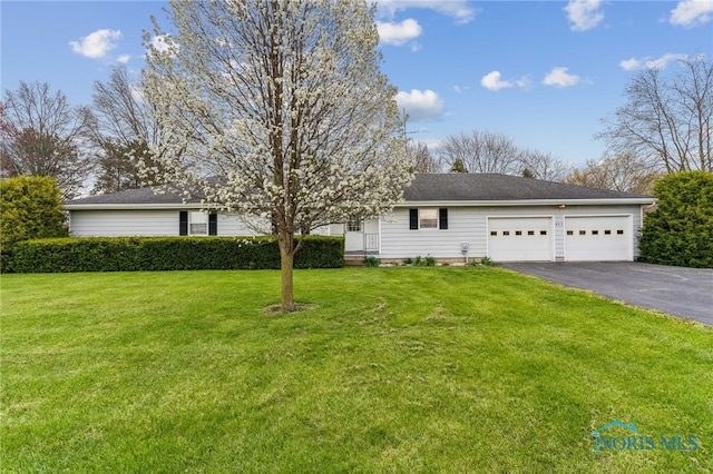 807 S Jefferson St, Pandora, OH 45877 - view of front of house with asphalt driveway, a garage, and a front yard