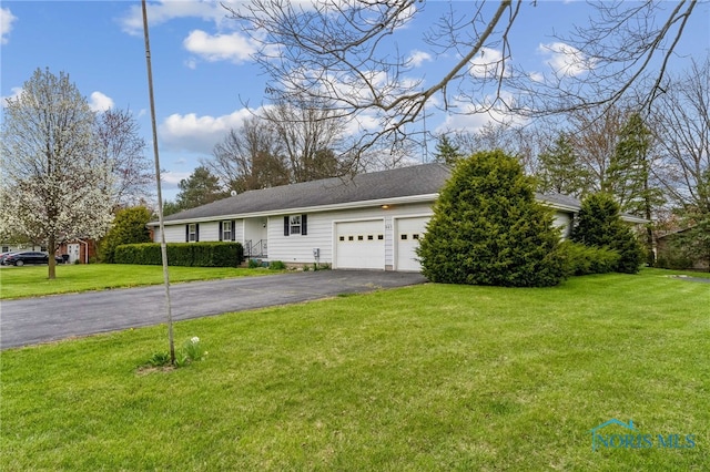 807 S Jefferson St, Pandora, OH 45877 - view of front facade featuring asphalt driveway, a garage, and a front yard