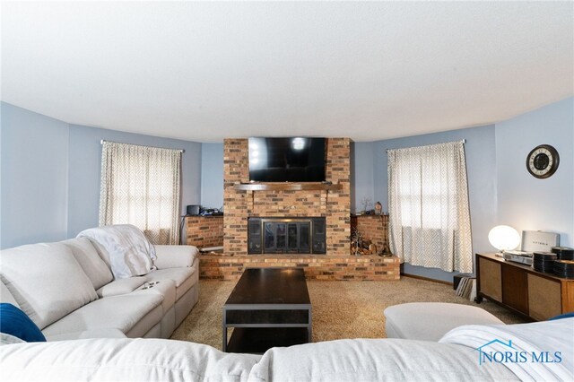 807 S Jefferson St, Pandora, OH 45877 - carpeted living area featuring healthy amount of natural light and a brick fireplace