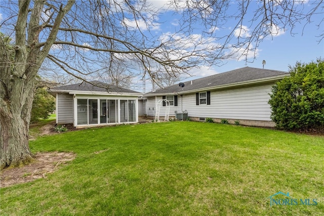 807 S Jefferson St, Pandora, OH 45877 - rear view of house with a yard and a sunroom