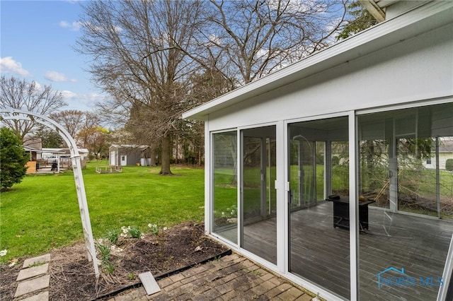 807 S Jefferson St, Pandora, OH 45877 - view of grassy yard featuring a sunroom