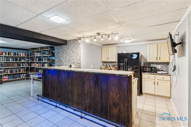 807 S Jefferson St, Pandora, OH 45877 - kitchen with light tile patterned floors, black appliances, backsplash, a drop ceiling, and cream cabinets