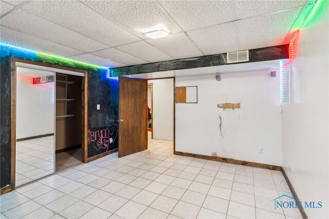 807 S Jefferson St, Pandora, OH 45877 - finished below grade area with a drop ceiling and light tile patterned flooring