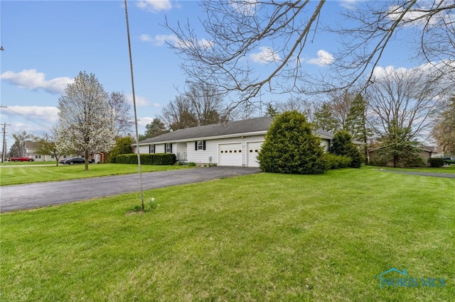 807 S Jefferson St, Pandora, OH 45877 - view of front of house with asphalt driveway, a garage, and a front lawn