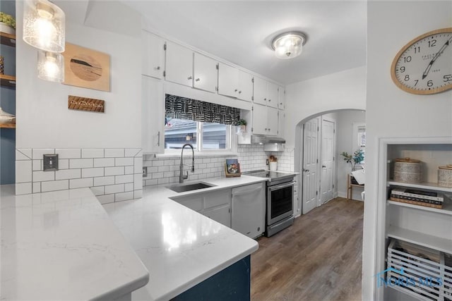 3418 Kirkwall Rd, Toledo, OH 43606 - kitchen with dishwasher, stainless steel electric stove, arched walkways, decorative backsplash, and white cabinetry