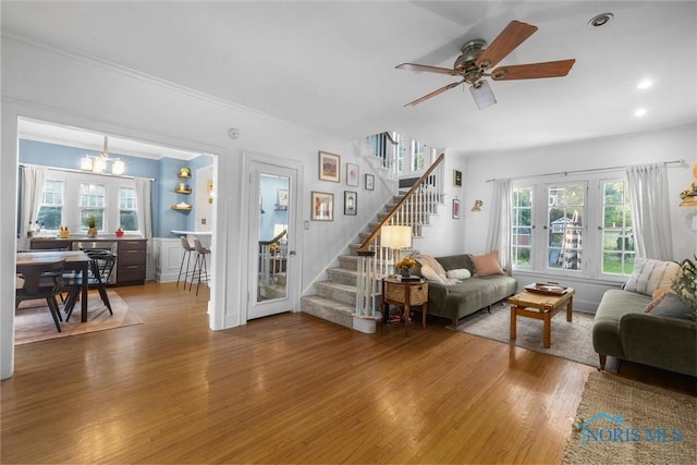 3418 Kirkwall Rd, Toledo, OH 43606 - living room featuring wood finished floors, stairway, plenty of natural light, crown molding, and a ceiling fan