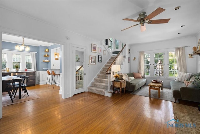 3418 Kirkwall Rd, Toledo, OH 43606 - living area with stairs, ornamental molding, healthy amount of natural light, light wood-type flooring, and a ceiling fan