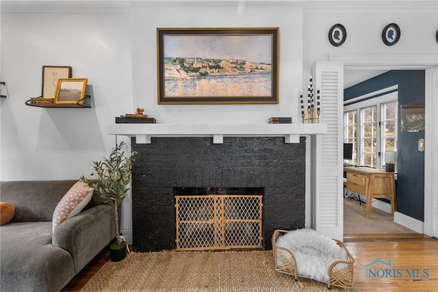 3418 Kirkwall Rd, Toledo, OH 43606 - living room featuring a fireplace with flush hearth and wood finished floors