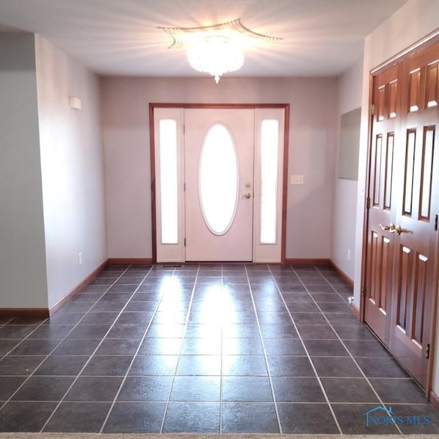 1623 Evan Dr, Defiance, OH 43512 - foyer with dark tile patterned floors and baseboards
