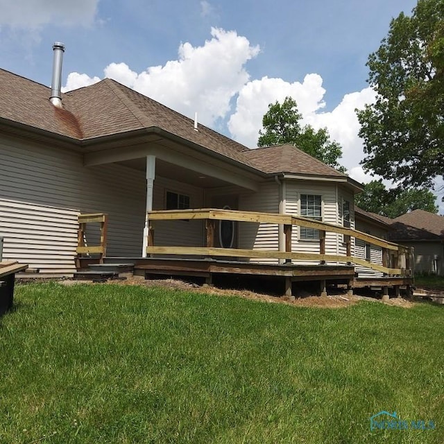 1623 Evan Dr, Defiance, OH 43512 - rear view of property with a yard, a wooden deck, and a shingled roof