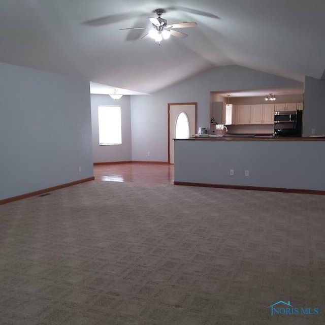 1623 Evan Dr, Defiance, OH 43512 - unfurnished living room with ceiling fan, lofted ceiling, and carpet