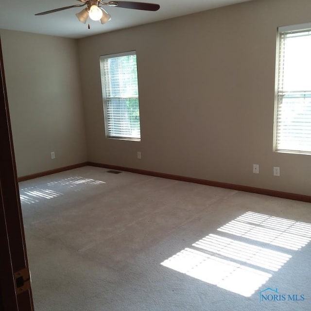 1623 Evan Dr, Defiance, OH 43512 - unfurnished room featuring light carpet, a ceiling fan, and plenty of natural light