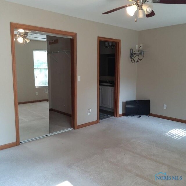 1623 Evan Dr, Defiance, OH 43512 - carpeted bedroom featuring a closet, ensuite bathroom, and ceiling fan