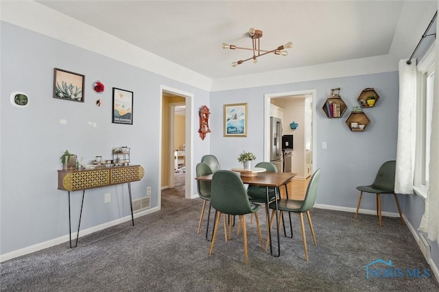 2624 Oak Grove Pl, Toledo, OH 43613 - carpeted dining room featuring a chandelier and baseboards