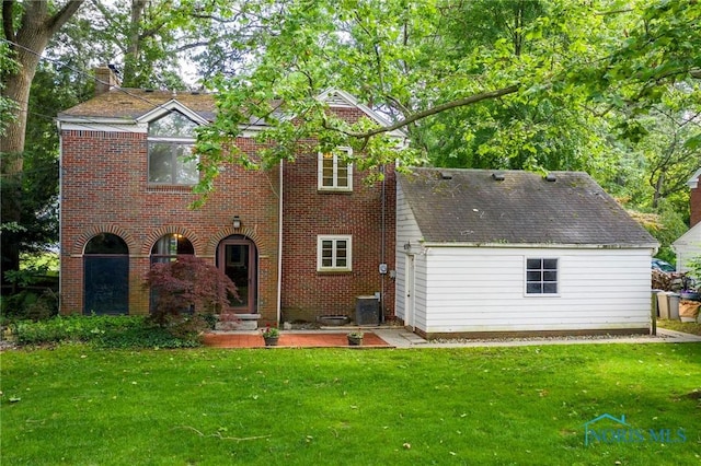 4146 Northmoor Rd, Ottawa Hills, OH 43606 - rear view of house with a lawn, brick siding, and a chimney