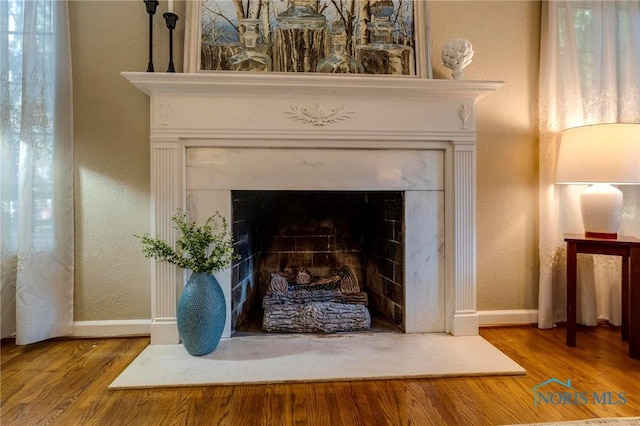 4146 Northmoor Rd, Ottawa Hills, OH 43606 - detailed view of wood finished floors, a fireplace with flush hearth, and a textured wall