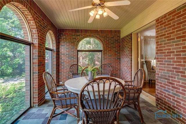 4146 Northmoor Rd, Ottawa Hills, OH 43606 - sunroom / solarium with brick wall, wood ceiling, a ceiling fan, and stone finish flooring