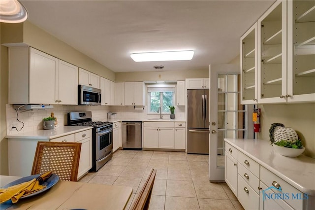 4146 Northmoor Rd, Ottawa Hills, OH 43606 - kitchen featuring stainless steel appliances, backsplash, light countertops, and white cabinetry