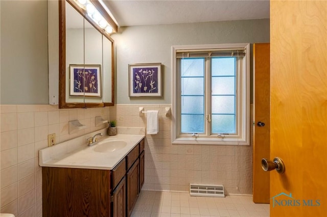 4146 Northmoor Rd, Ottawa Hills, OH 43606 - bathroom featuring vanity, tile walls, tile patterned flooring, and a wainscoted wall