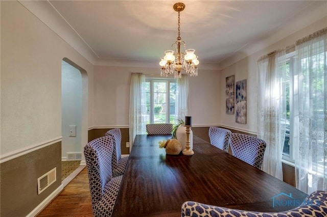 4146 Northmoor Rd, Ottawa Hills, OH 43606 - dining area featuring a chandelier, wood finished floors, and arched walkways