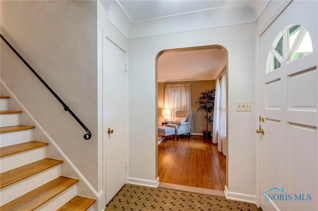 4146 Northmoor Rd, Ottawa Hills, OH 43606 - entrance foyer with light flooring, stairs, and arched walkways