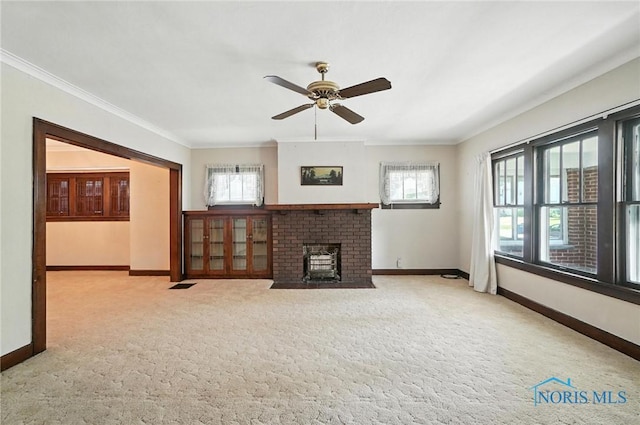 1452 Rollins Rd, Toledo, OH 43612 - unfurnished living room with ornamental molding, ceiling fan, carpet flooring, and a brick fireplace