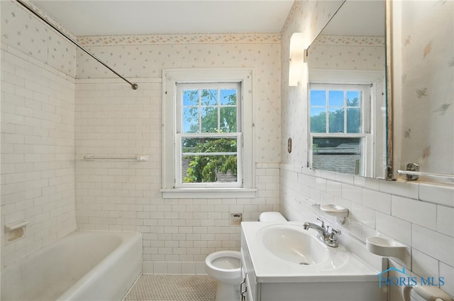 1452 Rollins Rd, Toledo, OH 43612 - full bath with plenty of natural light, wallpapered walls, vanity, tile walls, and wainscoting