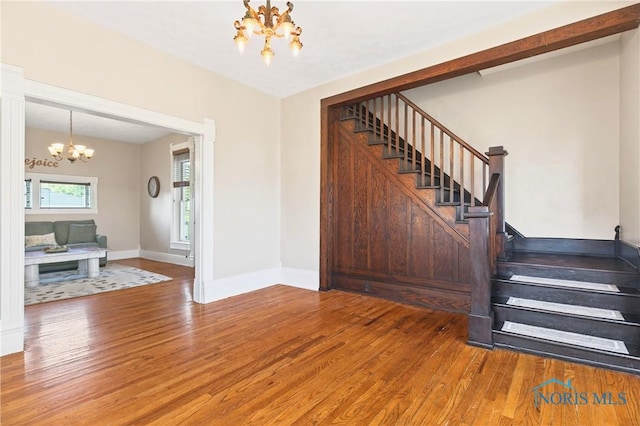 301 S High St, Pandora, OH 45877 - staircase with a chandelier and wood finished floors