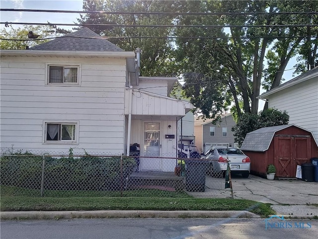 10 Edgewater, Toledo, OH 43611 - view of front of home with a fenced front yard, a shed, and roof with shingles