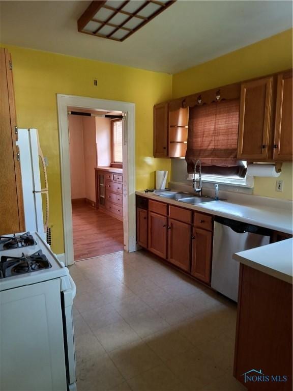 3906 Watson Ave, Toledo, OH 43612 - kitchen with white appliances, brown cabinetry, light floors, and light countertops