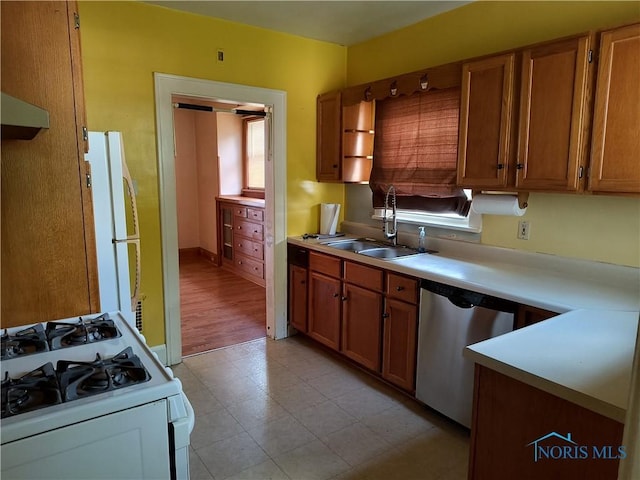 3906 Watson Ave, Toledo, OH 43612 - kitchen with white appliances, light countertops, brown cabinets, light floors, and exhaust hood