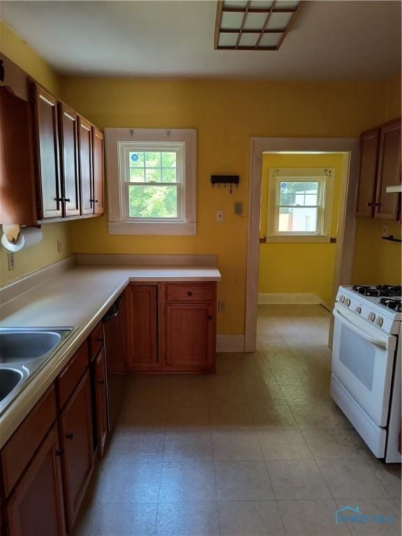 3906 Watson Ave, Toledo, OH 43612 - kitchen with white gas stove, healthy amount of natural light, and light countertops