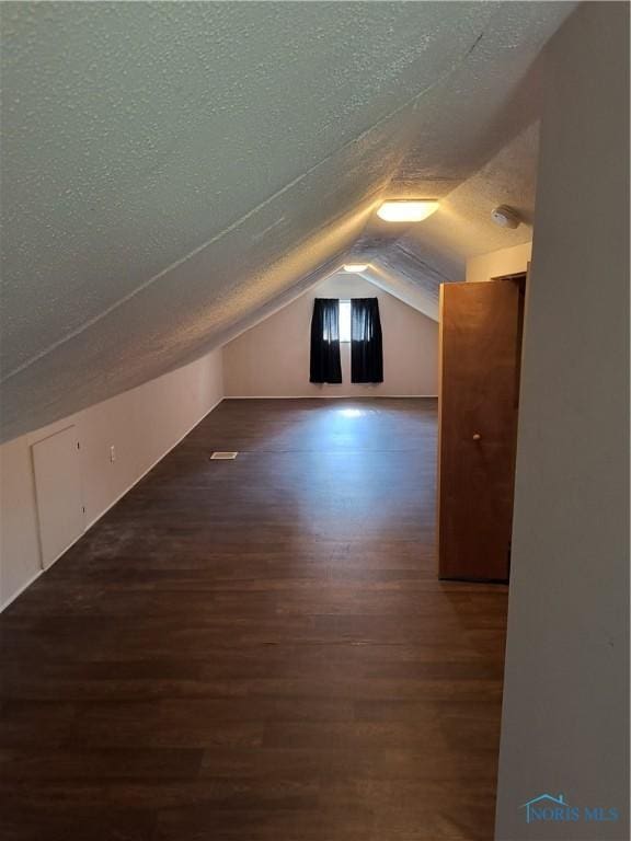 3906 Watson Ave, Toledo, OH 43612 - additional living space with a textured ceiling, wood finished floors, and vaulted ceiling
