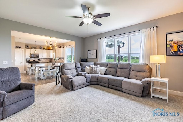 5539 Harris Hawk Ln, Sylvania, OH 43560 - living area featuring a chandelier and ceiling fan