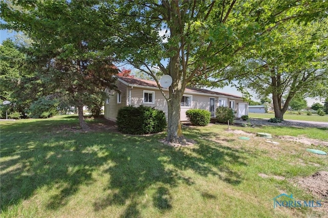 17918 Dunbridge Rd, Bowling Green, OH 43402 - view of front of property with an attached garage and a front yard