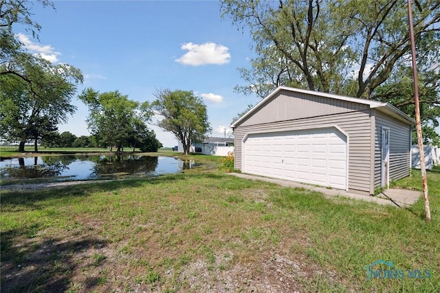 17918 Dunbridge Rd, Bowling Green, OH 43402 - view of grassy yard with a water view, a detached garage, and an outbuilding