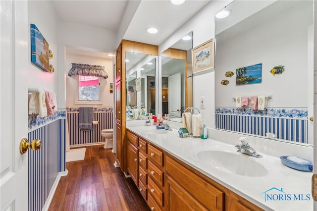 625 W Lake Ct Unit U5, Findlay, OH 45840 - bathroom featuring double vanity, wood finished floors, recessed lighting, and a wainscoted wall