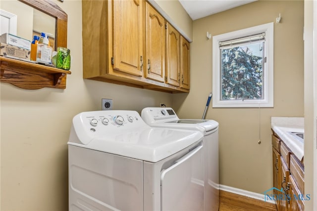 625 W Lake Ct Unit U5, Findlay, OH 45840 - washroom with cabinet space, washing machine and clothes dryer, and wood finished floors