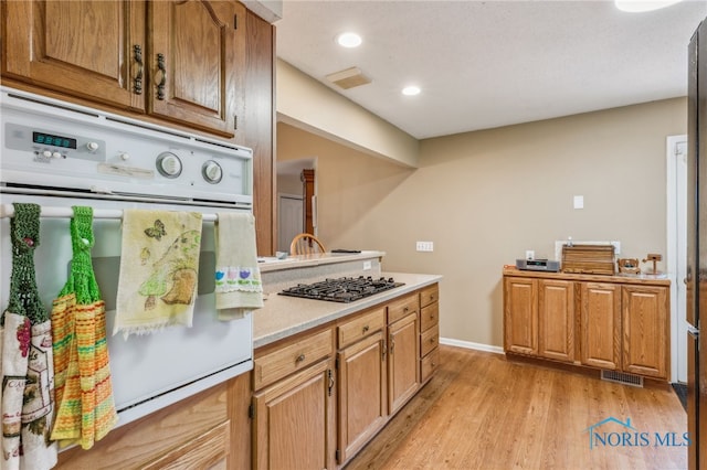 625 W Lake Ct Unit U5, Findlay, OH 45840 - kitchen featuring oven, gas stovetop, light countertops, light wood finished floors, and recessed lighting
